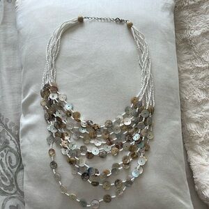 White beaded necklace with circular shells